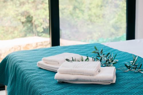 a group of towels sitting on top of a bed at Eden's Garden Villa in Ulcinj