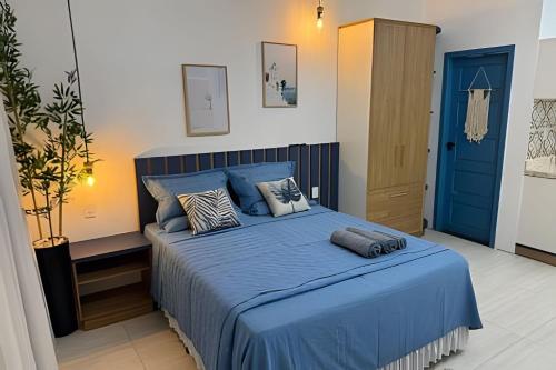 a bedroom with a blue bed and a blue door at Modern and fully equipped studios in Bosque, downtown area in Rio Branco