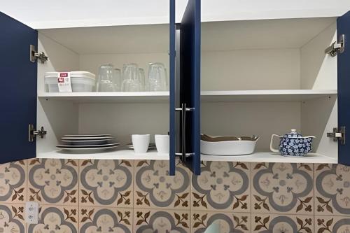 a cupboard with plates and dishes on it in a kitchen at Modern and fully equipped studios in Bosque, downtown area in Rio Branco