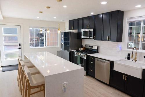 a kitchen with black cabinets and a white counter top at Modern Tahoe Retreat in South Lake Tahoe