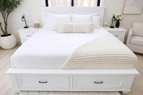 a white bedroom with a white bed with white furniture at Modern Tahoe Retreat in South Lake Tahoe