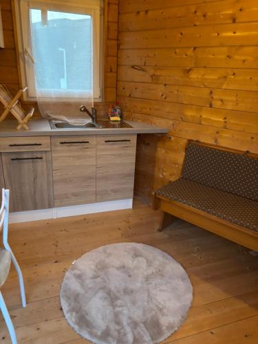 a kitchen with a bench and a sink and a table at Chalet à Rhodes in Rhodes