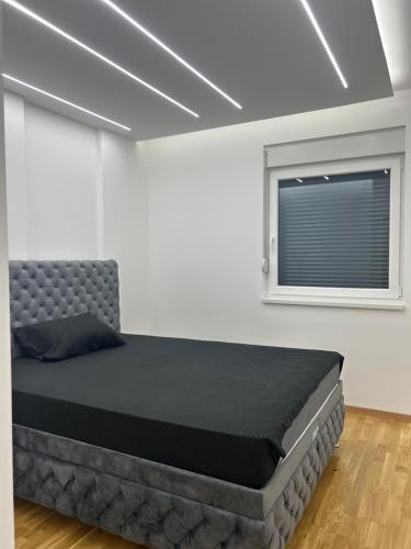 a bedroom with a bed and a window at Stan na dan in Loznica