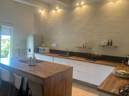 a kitchen with a wooden counter top and a sink at L écrin du Luberon in Cadenet
