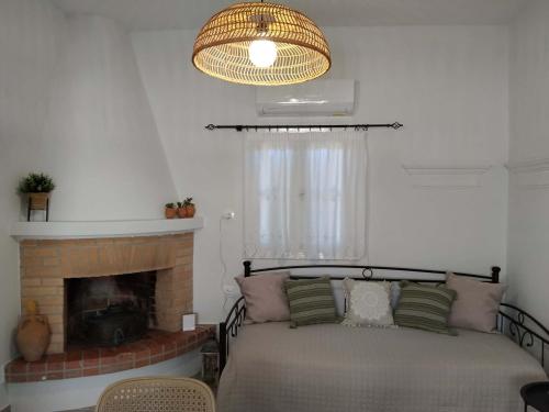 a bedroom with a bed and a fireplace at Liodentro House in Karpathos