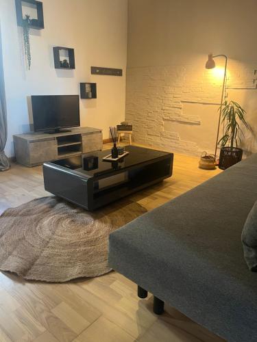 a living room with a couch and a coffee table at L écrin du Luberon in Cadenet