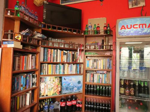 a book shelf filled with lots of books at Lake Vision Guesthouse in Pokhara