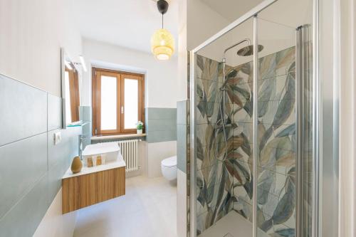 a bathroom with a shower with a glass door at Domio - Residenza del Corso in Atri