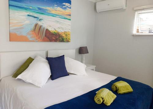 a bedroom with a bed with two towels on it at Ceelee's Place in Bloemfontein