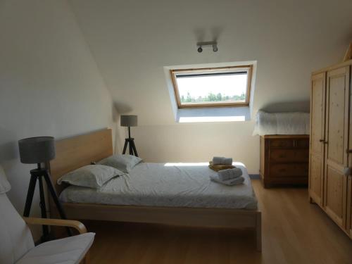 a bedroom with a bed and a window at L'auberge d'authie in Authie