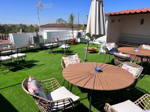 a patio with tables and chairs and an umbrella at Puertas de la Catedral in Córdoba