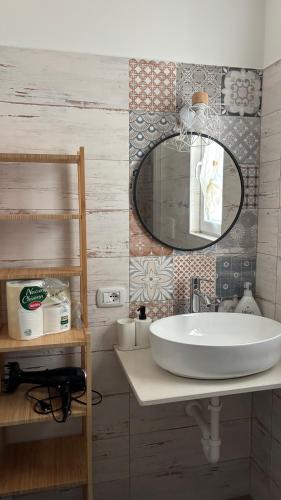 a bathroom with a sink and a mirror at Trulli bella vite in Putignano