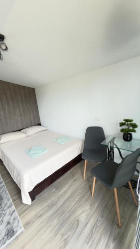 a bedroom with a bed and a table and chairs at Vraja din deal in Domneşti