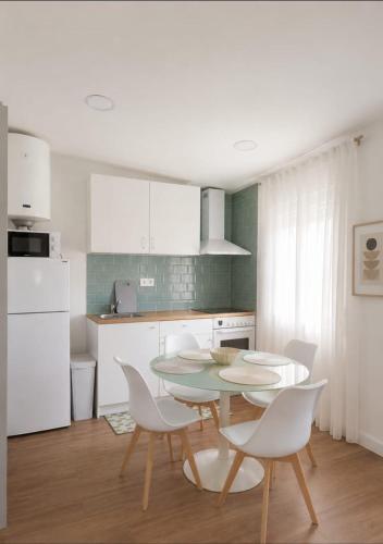 a kitchen with a table and chairs in a kitchen at La Casona de Carcedo 3 in OVD