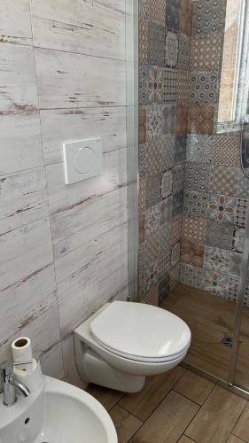 a bathroom with a toilet and a sink and a shower at Trulli bella vite in Putignano