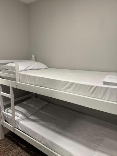 two bunk beds in a room next to each other at Comfort Zone in Porto Alegre