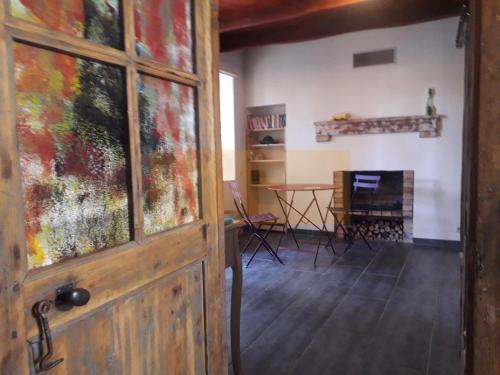 a door in a room with a table and a fireplace at Nuit pour 4 en Auvergne in Vallon-en-Sully