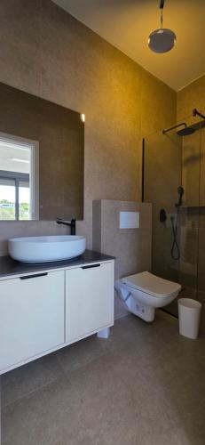 a bathroom with a tub and a sink and a toilet at Villa Castro in Ulcinj
