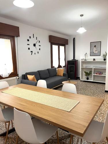 a living room with a table and a couch at Sunflower Apartment in Dogna