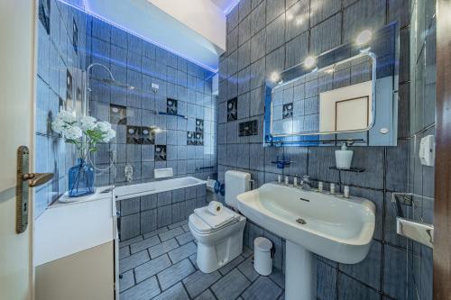 a bathroom with a sink and a toilet and a mirror at Classic Breeze - vista mare - terrazza - WiFi in Varazze