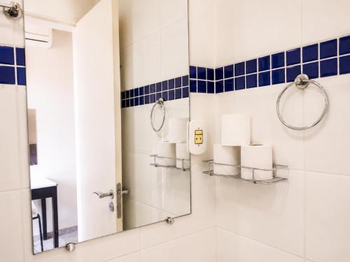 a bathroom with a shower and a mirror at Hotel El Pilar by Bsb Inn in Brasília