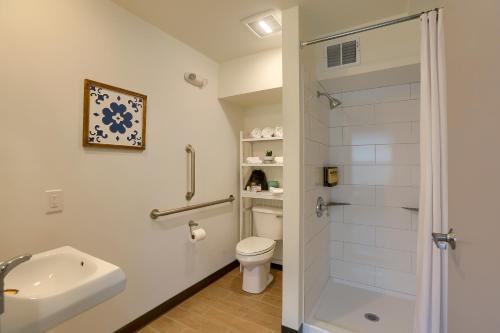 a white bathroom with a toilet and a shower at Sweet Stay in Hershey