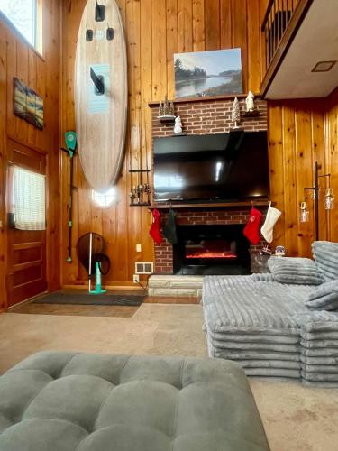 a living room with a couch and a piano at Cozy Waterfront Cottage in Beaverton