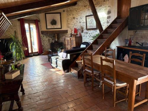 a living room with a staircase and a couch at La Parenthèse in Bourg-Saint-Andéol