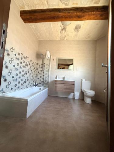 a bathroom with a tub and a sink and a toilet at Soleil B&B Gozo in Għarb