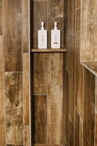 two bottles ofodorizers sit on shelves in a bathroom at Tiny Cabin #7 at The Cedars in Kanab