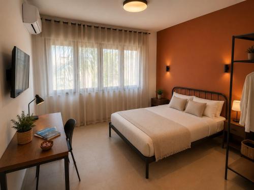 a bedroom with a bed and a desk and a window at Casa Pelagos in Brindisi