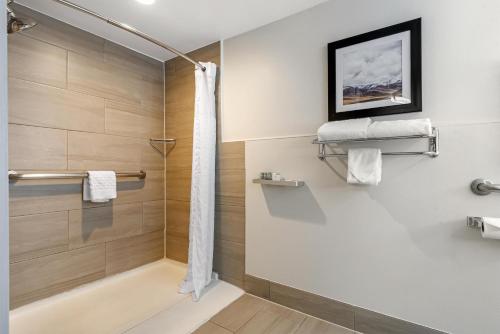 a bathroom with a shower with a glass door at Best Western Denver East in Denver