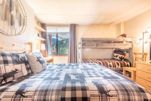 a bedroom with two bunk beds and a window at Village Square West 353 in Copper Mountain