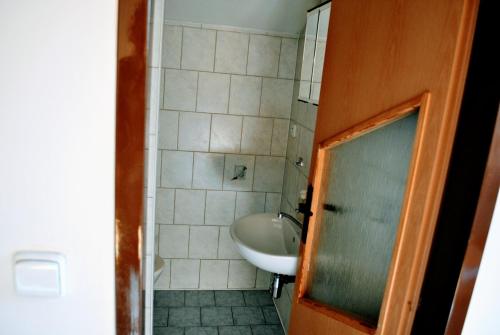 a small bathroom with a sink and a tub at Ubytovanie Zencuch in Drienica