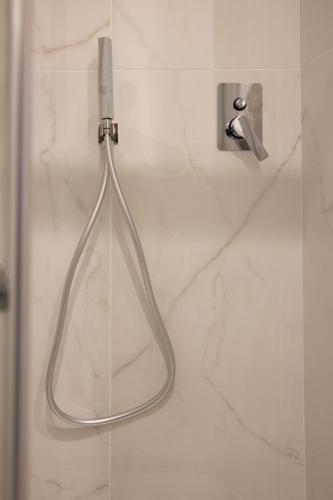 a shower with a glass door with aaucet at B&B Salerno Stay in Salerno