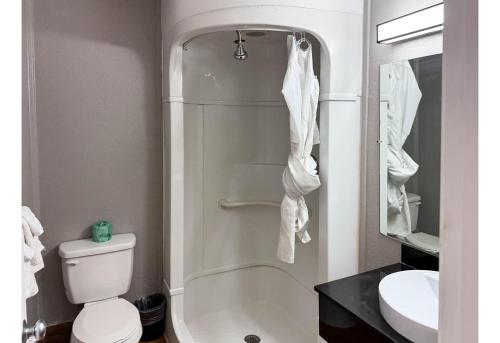 a bathroom with a shower and a toilet and a sink at Studio 6 Pecos Texas in Pecos