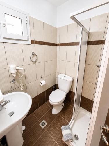 a bathroom with a toilet and a sink at Studios Plaka in Skala Kallirachis
