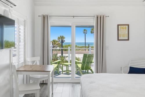 a bedroom with a bed and a view of the ocean at Inn on the Beach in St. Pete Beach