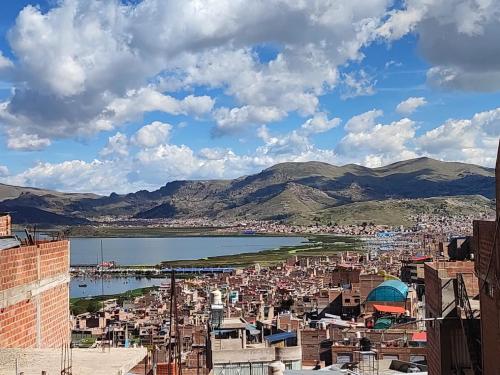 a view of a city and a body of water at Hospedaje wisny in in Puno
