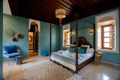 a bedroom with a canopy bed in a room at Daba Riads in Marrakesh