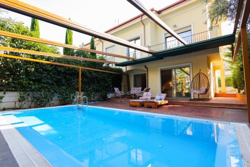 a swimming pool in front of a house at Pool and Spa Retreat Villa in Tirana
