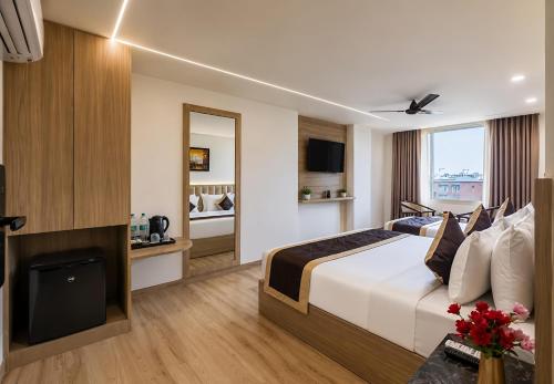 a hotel room with a bed and a tv at Hotel The Venue At Delhi Airport IGI in New Delhi