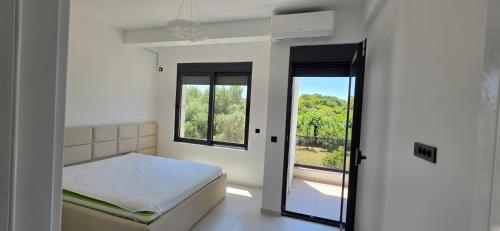 a small bedroom with a bed and a window at Villa Castro in Ulcinj