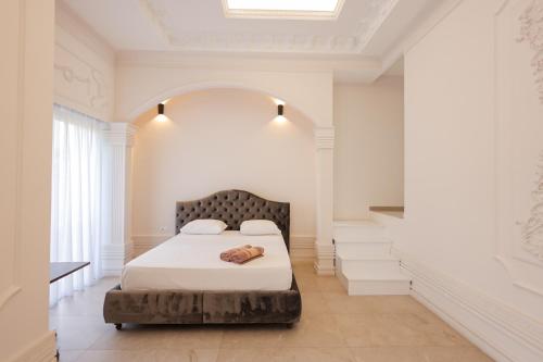 a bedroom with a bed in a white room at Pool and Spa Retreat Villa in Tirana