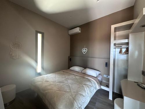 a bedroom with a bed and a window at Karya View 2 in Kariá