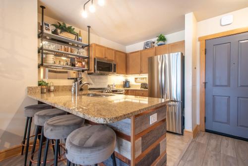 a kitchen with a counter and a refrigerator at Copper Springs Lodge 332 in Copper Mountain