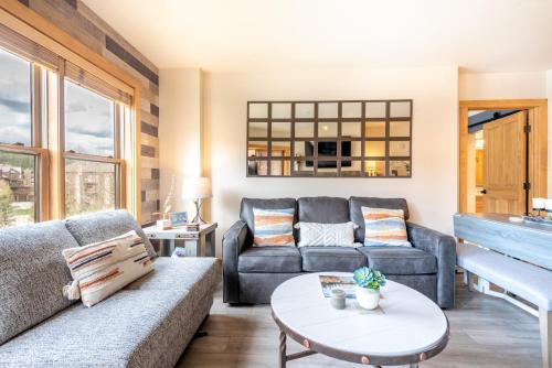 a living room with a couch and a piano at Copper Springs Lodge 332 in Copper Mountain