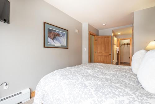 a bedroom with a large bed and a television at Copper Springs Lodge 301 in Copper Mountain