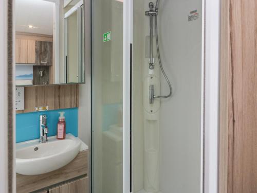 a bathroom with a sink and a shower at Craig Tara Holiday Park 101 Bay View in Ayr