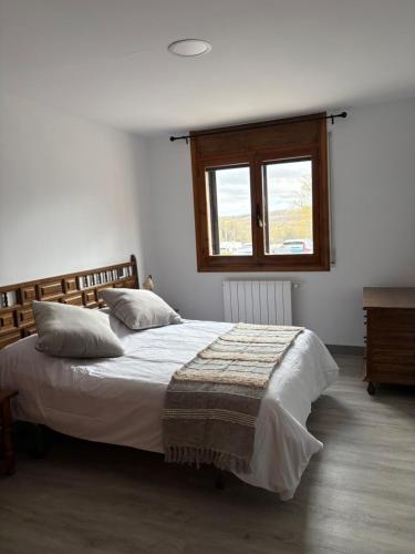 a bedroom with a bed and a window at El Rincón De Tere in Riaza
